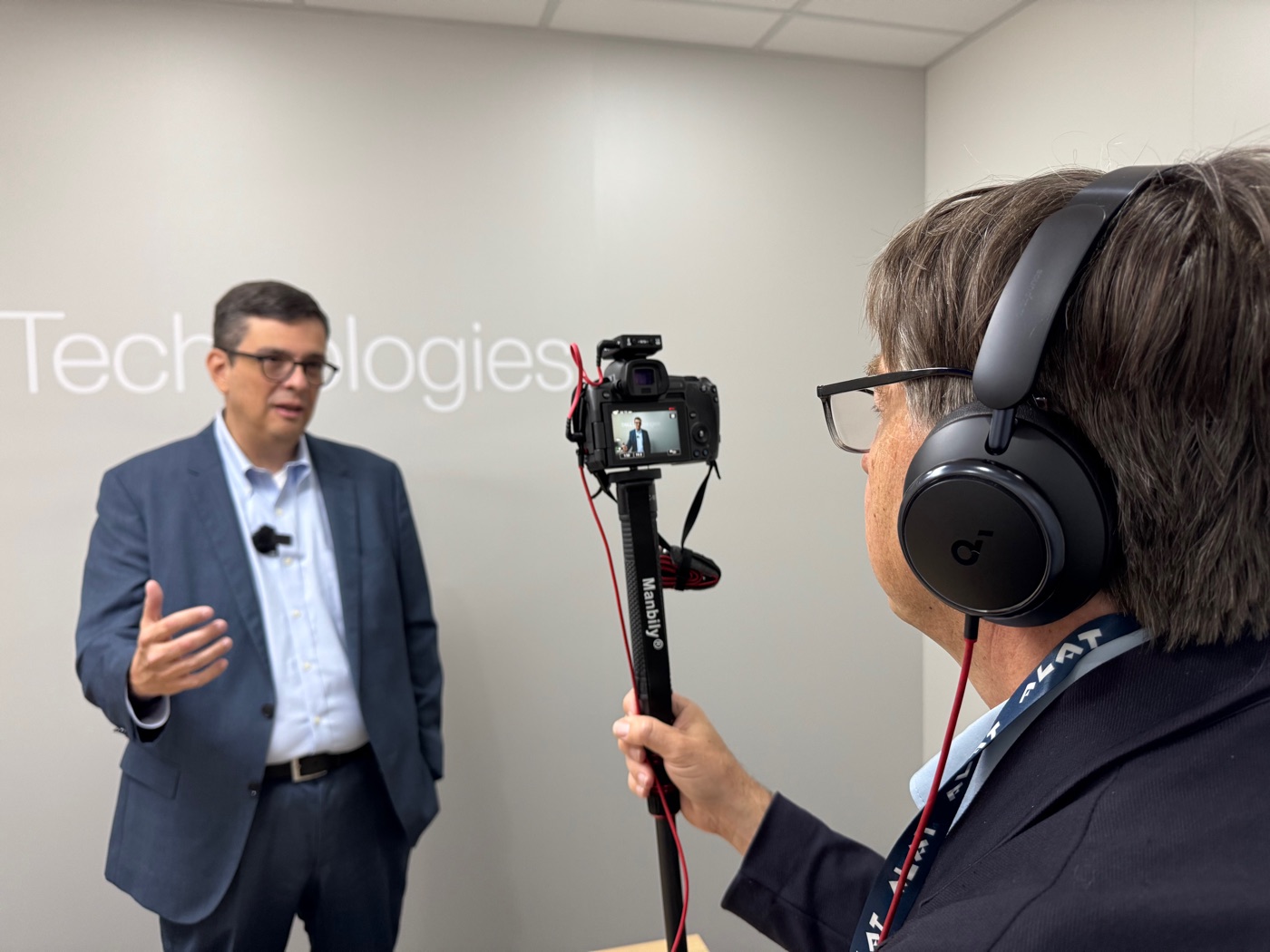 A NextGenInfra executive video interview being filmed on location at an industry event.